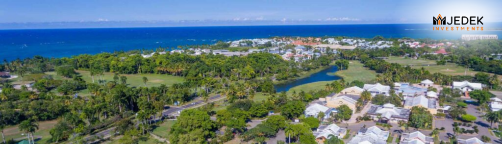 A view of Playa Dorada's golden sand beach with crystal-clear waters, surrounded by lush tropical landscapes and Mount Isabel de Torres.